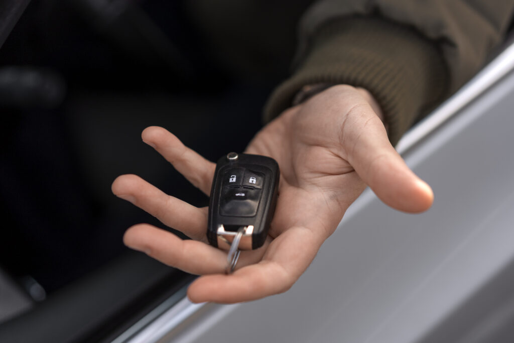 High angle hand holding car key